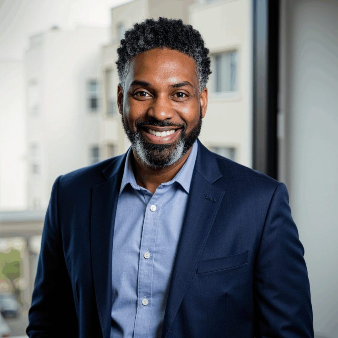 Smiling professional in navy suit by window